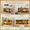 A collage of four images showing a wooden shelf unit in different settings: a living room, an entrance, a child's room, and a kindergarten. The shelf is filled with books, decorative items, and toys. Produktbild-Vorschau