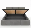 A grey upholstered bed frame with the storage compartment open, revealing the wooden slatted base. Náhled obrázku produktu