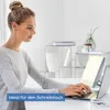 A woman is working on a laptop at a desk with a daylight lamp. Podgląd zdjęcia produktu
