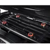 Interior view of a black roof box, showing the mounting system with red and black knobs. Produktbild-Vorschau
