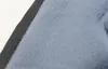 A close-up view of a blue furry seat cover with a black edge. Produktbild-Vorschau