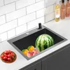 A kitchen sink with various fruits inside, including a watermelon, oranges, apples, and tomatoes on a wooden plate. Podgląd zdjęcia produktu