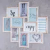 A collage of framed pictures arranged on a gray surface. Produktbild-Vorschau