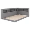 A gray corner bed frame with built-in shelving and a slatted mattress base. Produktbild-Vorschau