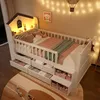 A child's bed with storage drawers and shelves, decorated with fairy lights and a picture on the wall. Náhľad obrázku produktu