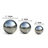 Three polished stainless steel garden balls of different sizes are displayed on a white background, with size indicators above each ball. Náhled obrázku produktu