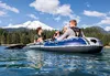 Four people are in an inflatable boat on a lake with a snow-capped mountain and trees in the background. Podgląd zdjęcia produktu