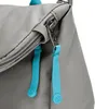 A close-up view of a gray bag with two blue zipper pulls. Produktbild-Vorschau