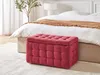 A red tufted storage ottoman is placed in front of a bed in a bedroom setting. Náhled obrázku produktu