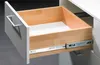 An open drawer with wooden interior and metal drawer slides. Produktbild-Vorschau