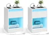 Two white nightstands with blue LED lighting, each displaying a digital clock and books. Náhled obrázku produktu