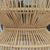 A close-up view of a rattan side table, showing the woven texture of the material. Produktbild-Vorschau