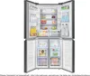 The interior of a refrigerator and freezer combination, with doors open, showing various food and drink items. Produktbild-Vorschau
