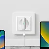 A white USB-C GaN 30W Netzladegerät is plugged into a white wall socket. A white charging cable is connected to the charger and extends downwards. A smartphone is partially visible on the left, and a tablet is partially visible on the right, both appearing Anteprima dell’immagine prodotto