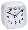 A white analog alarm clock with a silver bezel, shown from a diagonal angle against a white background. Produktbild-Vorschau