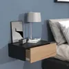 A floating nightstand with an open drawer next to a bed. Produktbild-Vorschau