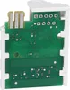 A close-up view of a green circuit board with white plastic housing. Náhľad obrázku produktu