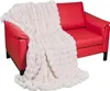 A cream-colored faux fur blanket draped over a red sofa. Produktbild-Vorschau