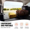 Inside of a vehicle with luggage and a folded blanket, with a beach scene visible through the open rear. Anteprima dell’immagine prodotto