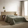 A bedroom scene featuring a wooden headboard with integrated storage, a bed with green bedding, and decorative elements. Anteprima dell’immagine prodotto