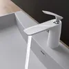 A modern white faucet is installed on a white sink, with water flowing from the faucet. Produktbild-Vorschau