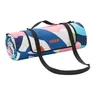 A rolled-up picnic blanket with a colorful abstract pattern and black carrying straps, displayed against a white background. Náhled obrázku produktu