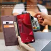 A person is using a phone case with card slots while making a payment at a terminal. Produktbild-Vorschau
