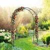 A garden scene with a metal arch covered in flowers. Podgląd zdjęcia produktu