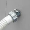 A close-up view of a white corrugated hose connected to a gray adapter fitting, which is inserted into a gray wall. Voir les images du produit