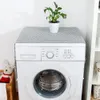 A washing machine with a patterned cover on top, and a plant in a pot. Podgląd zdjęcia produktu