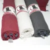 Three rolled-up chair cushions in different colors (red, cream, gray) are displayed on a white background. Produktbild-Vorschau