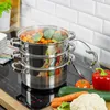 A stainless steel steamer pot with vegetables being steamed on an induction cooktop. Voir les images du produit