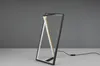 A modern LED table lamp with a geometric design, presented on a plain surface against a gray background. Náhľad obrázku produktu