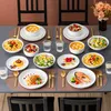 A beautifully set dining table with various dishes and place settings. Náhled obrázku produktu