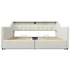 Front view of a beige upholstered bed frame with its mattress support slats visible. The bed has a headboard with vertical tufting and appears to have storage drawers underneath. The frame is shown without a mattress. Produktbild-Vorschau