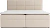 A beige upholstered box spring bed with a white mattress topper. Voir les images du produit