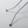 A close-up view of the white metal legs and feet of an ironing board. Anteprima dell’immagine prodotto