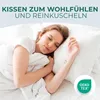 A woman sleeping peacefully on a bed with pillows. Produktbild-Vorschau