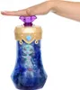 A hand presses down on the top of a toy bottle containing a doll. Podgląd zdjęcia produktu