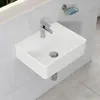 A white ceramic sink mounted on a tiled wall. Anteprima dell’immagine prodotto