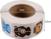 A roll of round stickers with cartoon animal faces, with dimensions indicated by text overlays. Produktbild-Vorschau