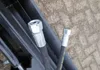 Close-up of hydraulic hoses with metal fittings attached to black machinery. Produktbild-Vorschau