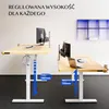 Two adjustable height desks are shown in an office setting. The desk on the left has headphones hanging from it, and the desk on the right has a laptop and a phone on it. The desks are white and light wood. Podgląd zdjęcia produktu