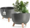 Two gray planters with ribbed texture and wooden legs are shown. One planter is in the foreground and contains plants, while the other is in the background. Náhled obrázku produktu