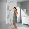 A woman is using a modern shower panel system in a bathroom. Produktbild-Vorschau