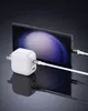 A white and black charger is shown plugged into a smartphone, with cables connecting them. Produktbild-Vorschau