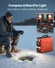 A man ice fishing at night with a portable generator providing light. Produktbild-Vorschau