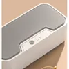A close-up shot of a white and gray ultrasonic cleaner. Produktbild-Vorschau