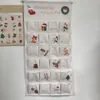 A fabric advent calendar with 24 pockets, each decorated with a Christmas-themed image and number. Anteprima dell’immagine prodotto