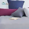 A collection of pillows and a book on a bed. Produktbild-Vorschau
